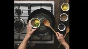 In the hot oil, add cumin seeds, green chilies, ginger, and a pinch of asafoetida (hing). Sauté for 1–2 minutes.