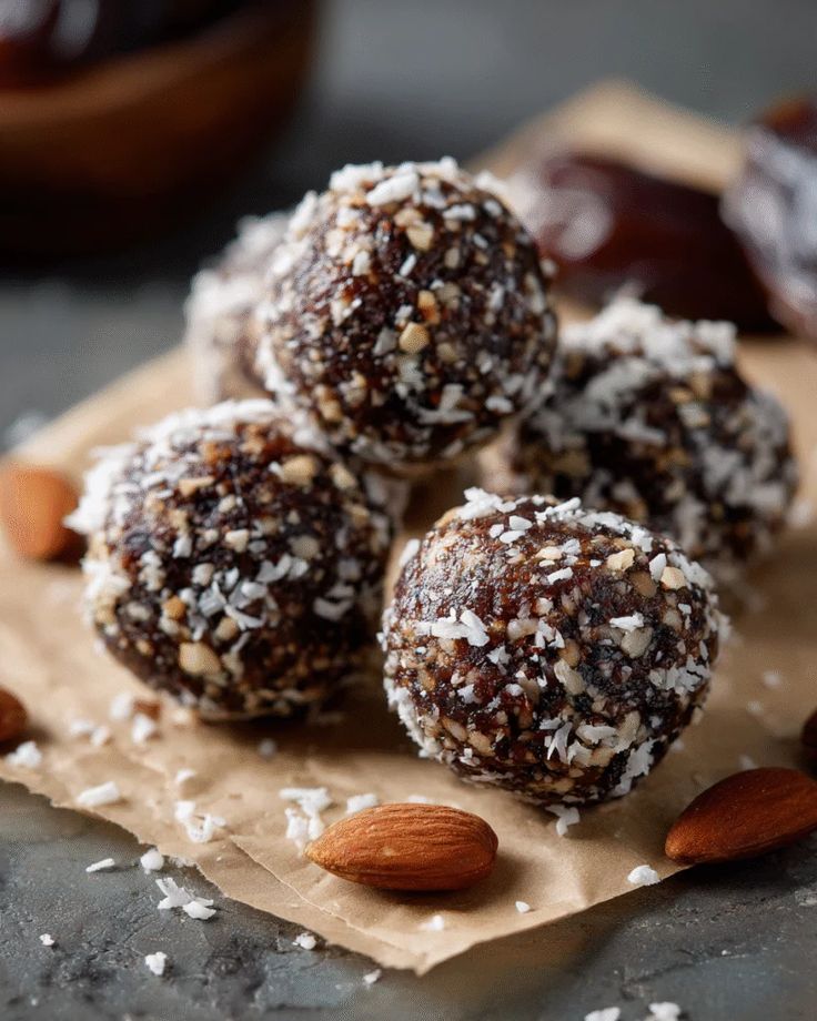 This may contain: nuts and almonds are on top of a piece of paper with some kind of food in the background