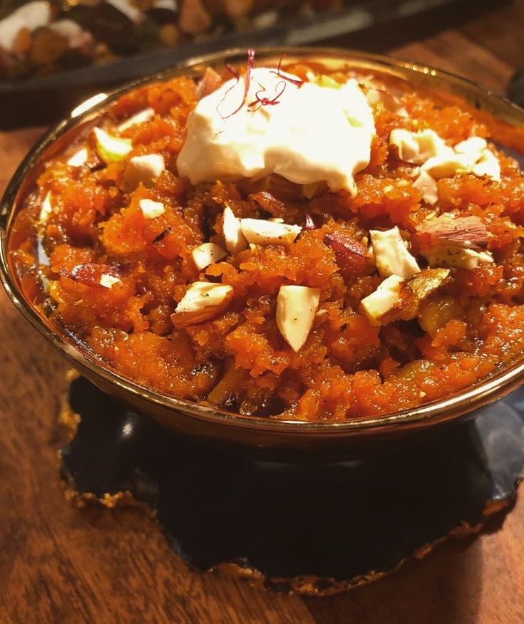 This may contain: a bowl filled with food sitting on top of a wooden table