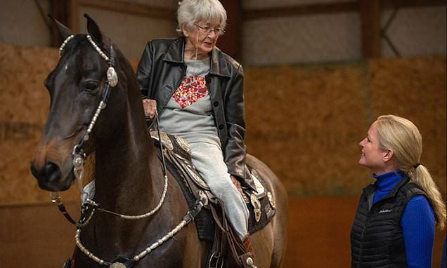 This may contain: an older woman sitting on the back of a brown horse next to a younger woman