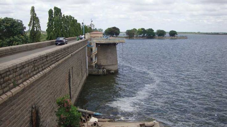 This may contain: a boat traveling down a river next to a brick wall