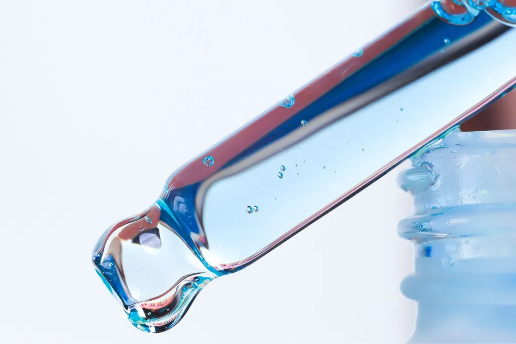 A dropper filled with a blue liquid.