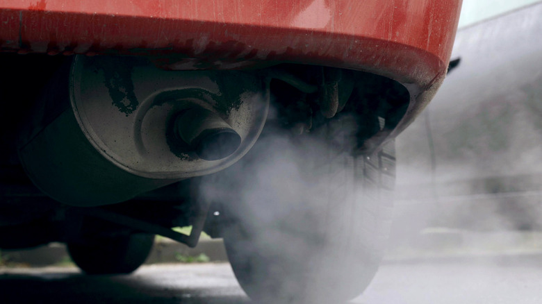 A car's muffler pumping out exhaust.
