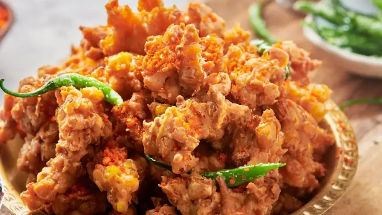 crispy corn fritters in plate served with green chilies
