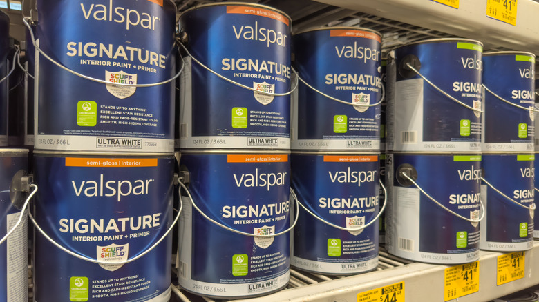 Picture showing paint cans on a shelf