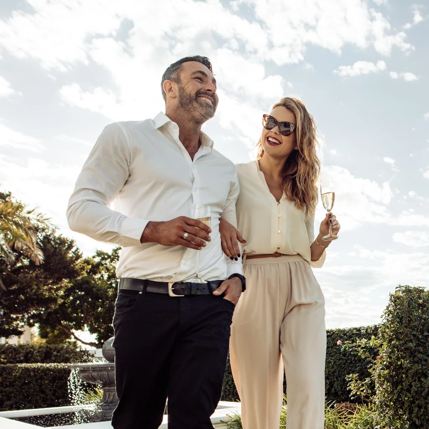 happy wealthy couple walking outside