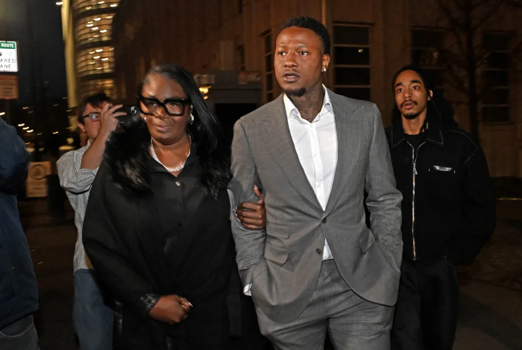Terry Rozier (pictured, gray suit) leaves court after his status hearing for his gambling case on Monday, December 8th. He has been charged with crimes related to gambling. At the US Federal Courthouse for the Eastern District of New York, 225 Cadman Plaza East, Brooklyn, NY.