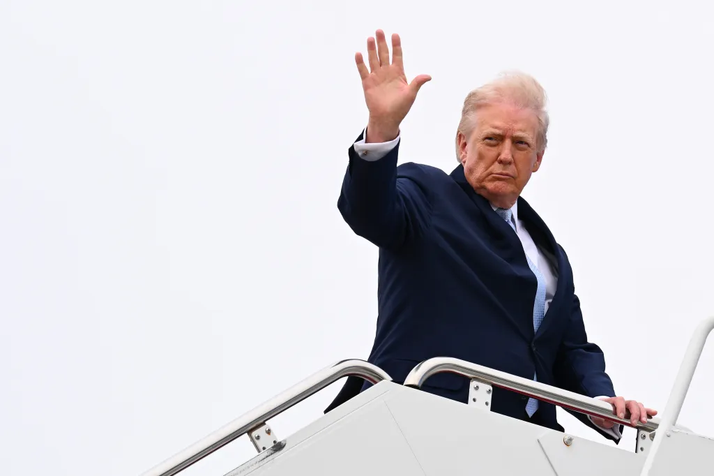 Donald Trump waves as he boards Air Force One on March 20, 2026 at Joint Base Andrews, Maryland to spend another weekend at his Mar-a-Lago resort.
