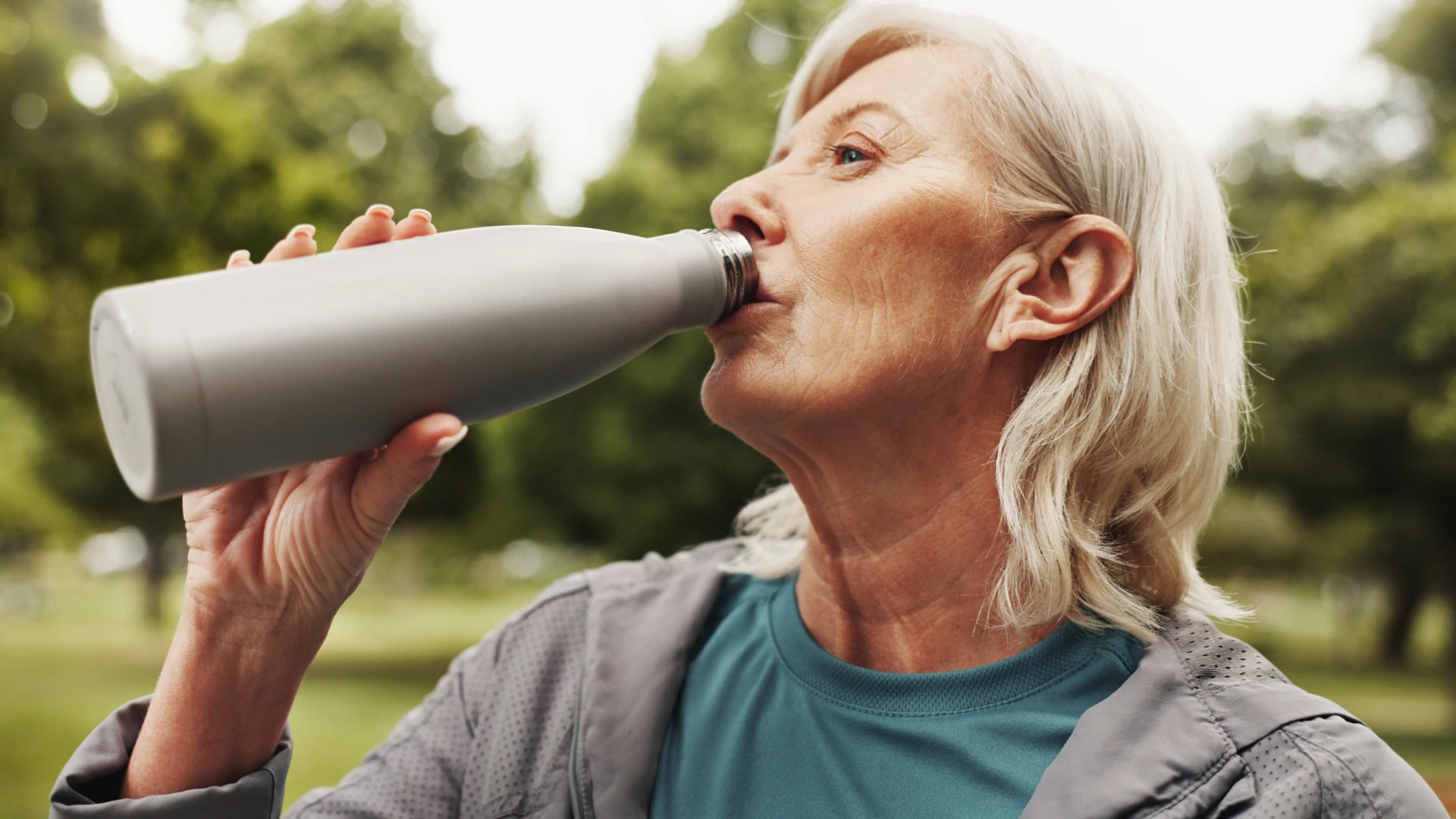 woman drinking from an unwashed water bottle