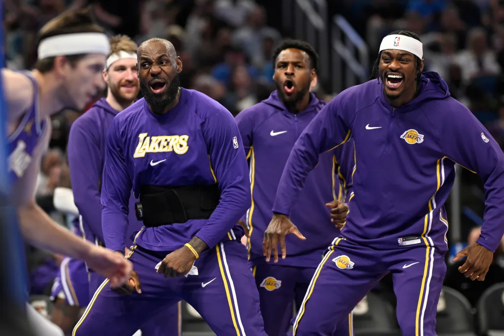 Lakers players, including LeBron James, celebrate