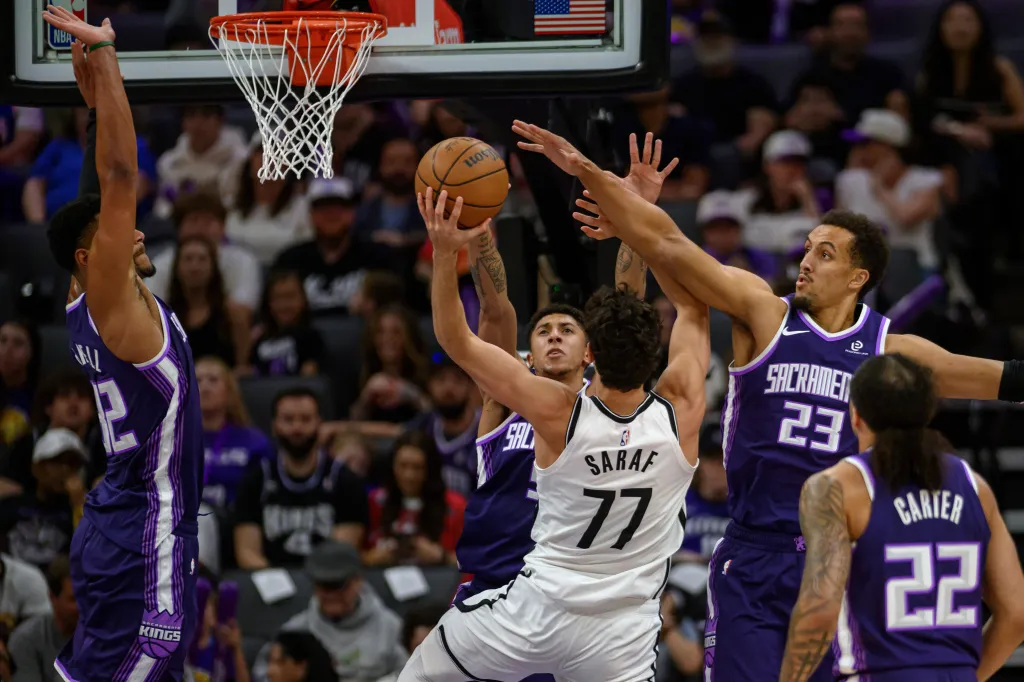 Ben Saraf (77) of the Brooklyn Nets attempts a shot over Dylan Cardwell, Nique Clifford, Patrick Baldwin Jr. (23), and Devin Carter (22) of the Sacramento Kings.