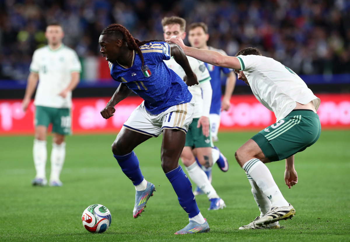 BERGAMO, ITALY - MARCH 26: Moise Kean of Italy is challenged by Ruairi McConville of Northern Ireland during the FIFA World Cup 2026 European Qualifiers KO play-offs match between Italy and Northern Ireland at Stadio di Bergamo on March 26, 2026 in Bergamo, Italy. (Photo by Marco Luzzani/Getty Images)