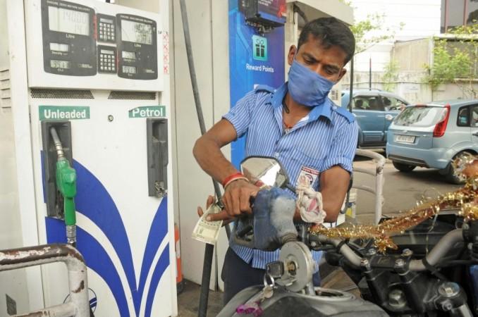 An employee refills petrol in a vehicle at a petrol pump (File photo)