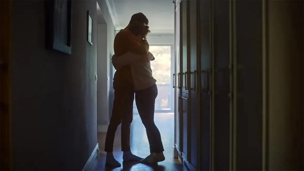 man and woman hugging each other
