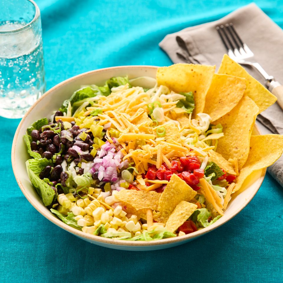 a recipe photo of Black Bean Taco Bowls with Lime Crema Credit: Photographer: Jacob Fox, Food Stylist: Sammy Mila, Prop Stylist: Joseph Wanek.