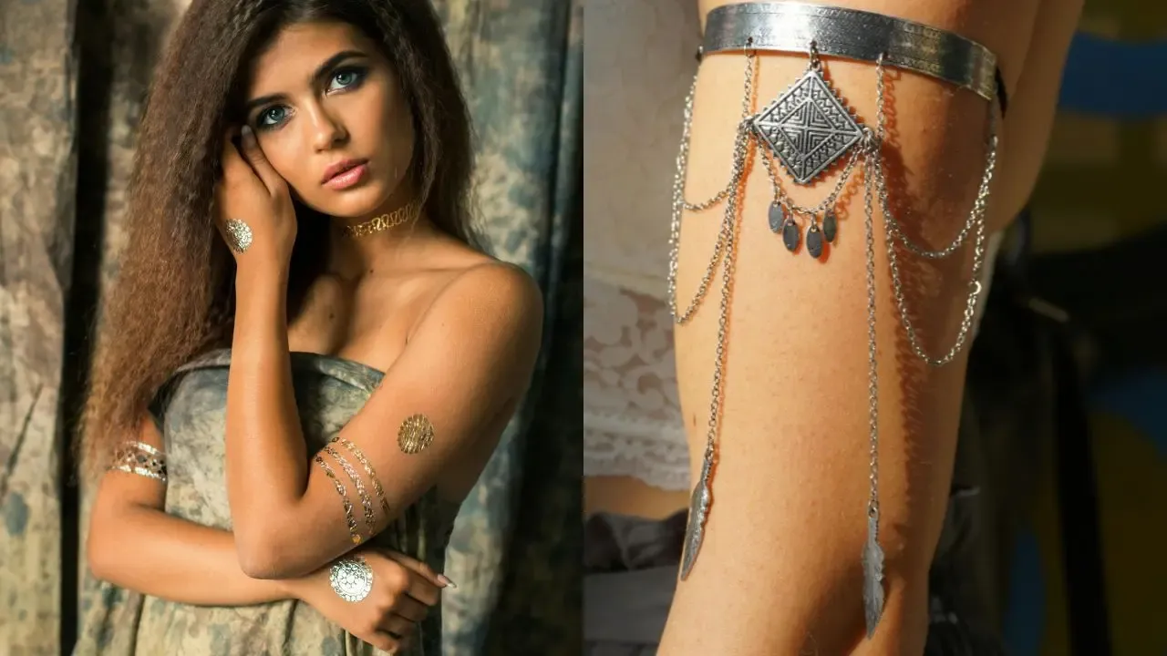 A young woman wearing stylish armlets and body jewelry, including delicate chain arm cuffs and a decorative thigh accessory with intricate metallic detailing.