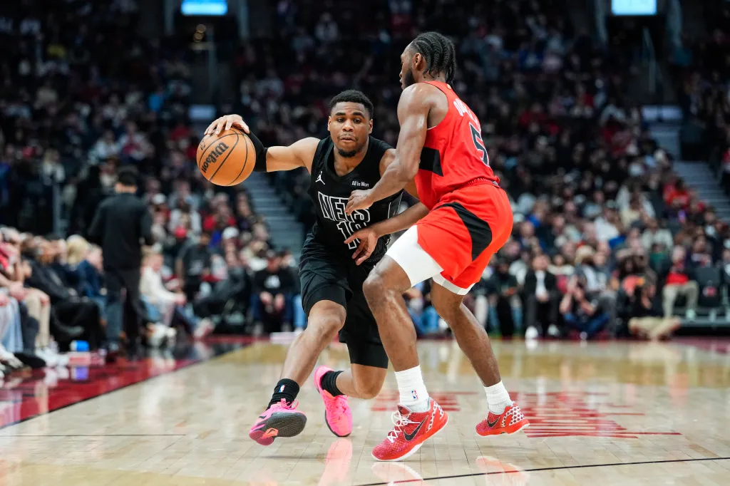 Malachi Smith of the Brooklyn Nets dribbles against Immanuel Quickley of the Toronto Raptors.