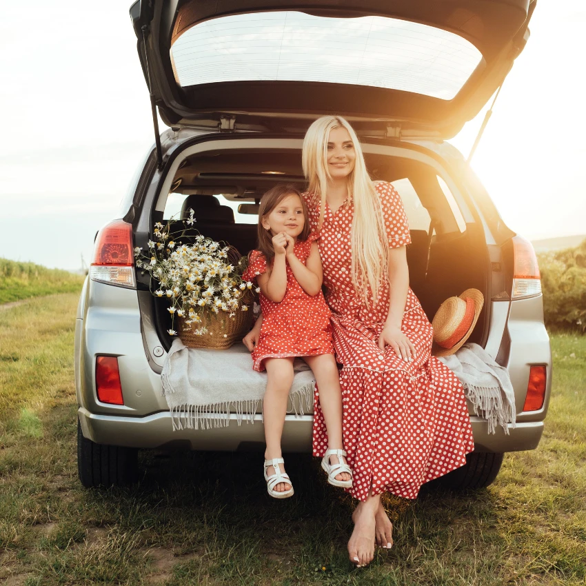 mom with her daughter in gray suv