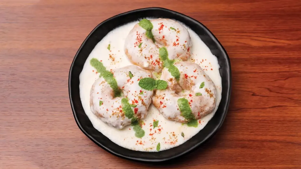 Distorted and flipped image of a person with curly hair and dark clothing, partially obscured and unclear.