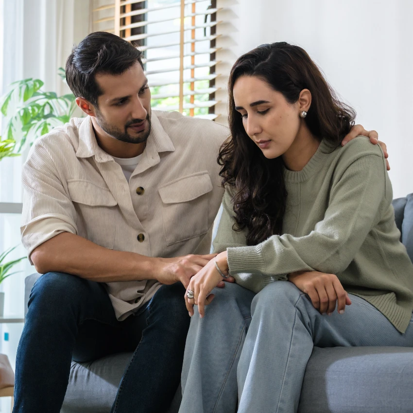 parents sitting on couch and deciding how to split responsbilities