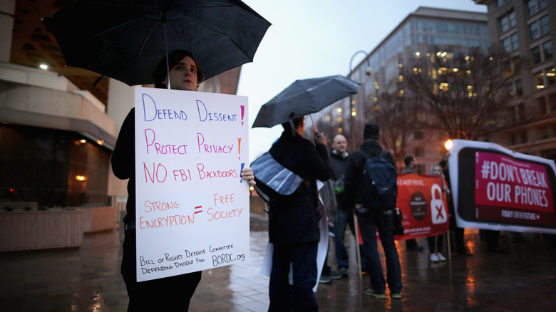 protestors demonstrate outside the FBI headquarters against a move by the federal government to force the company to create a 