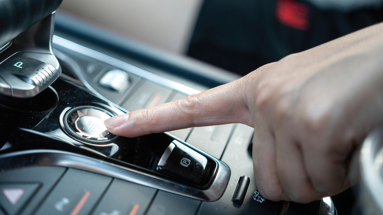 Person pressing the engine start button