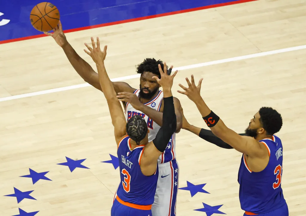 New York Knicks guard Josh Hart (3) and New York Knicks center Karl-Anthony Towns (32) double team Philadelphia 76ers center Joel Embiid (21) in the fourth quarter. 