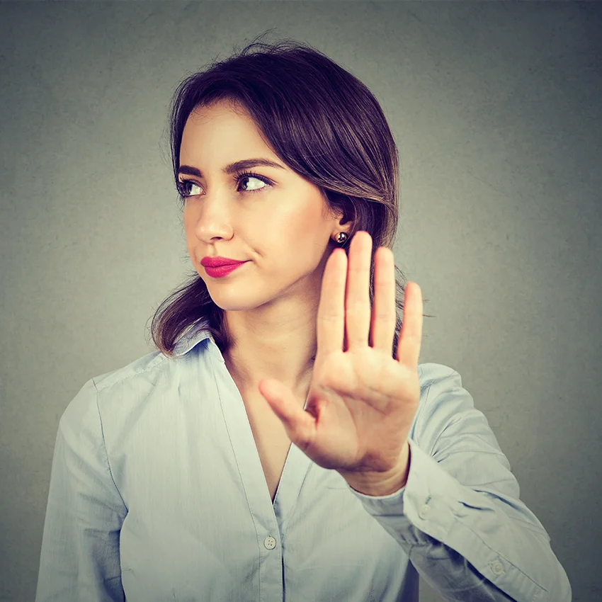 woman holding up hand annoyed