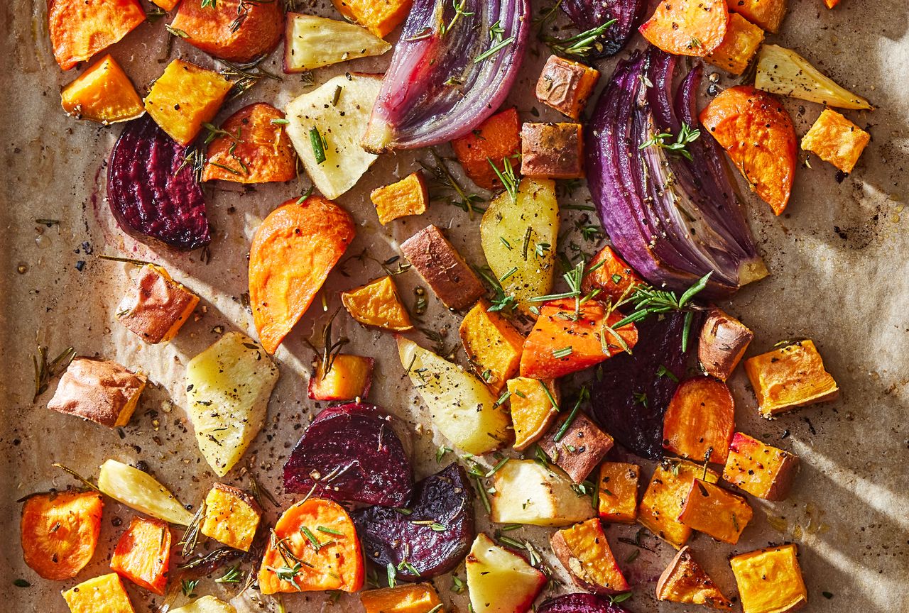 Sheet-pan roasted vegetables on a baking sheet topped with fresh herbs Credit: Photographer: Rachel Marek, Food Stylist: Holly Dreesman, Prop Stylist: Sue Mitchell