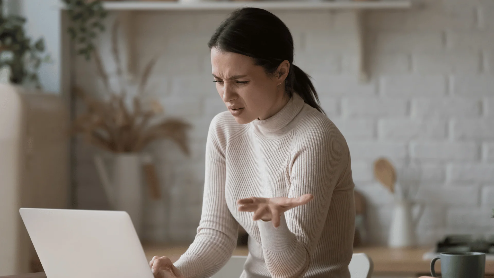 Woman who needs a break looks at her computer with frustration 