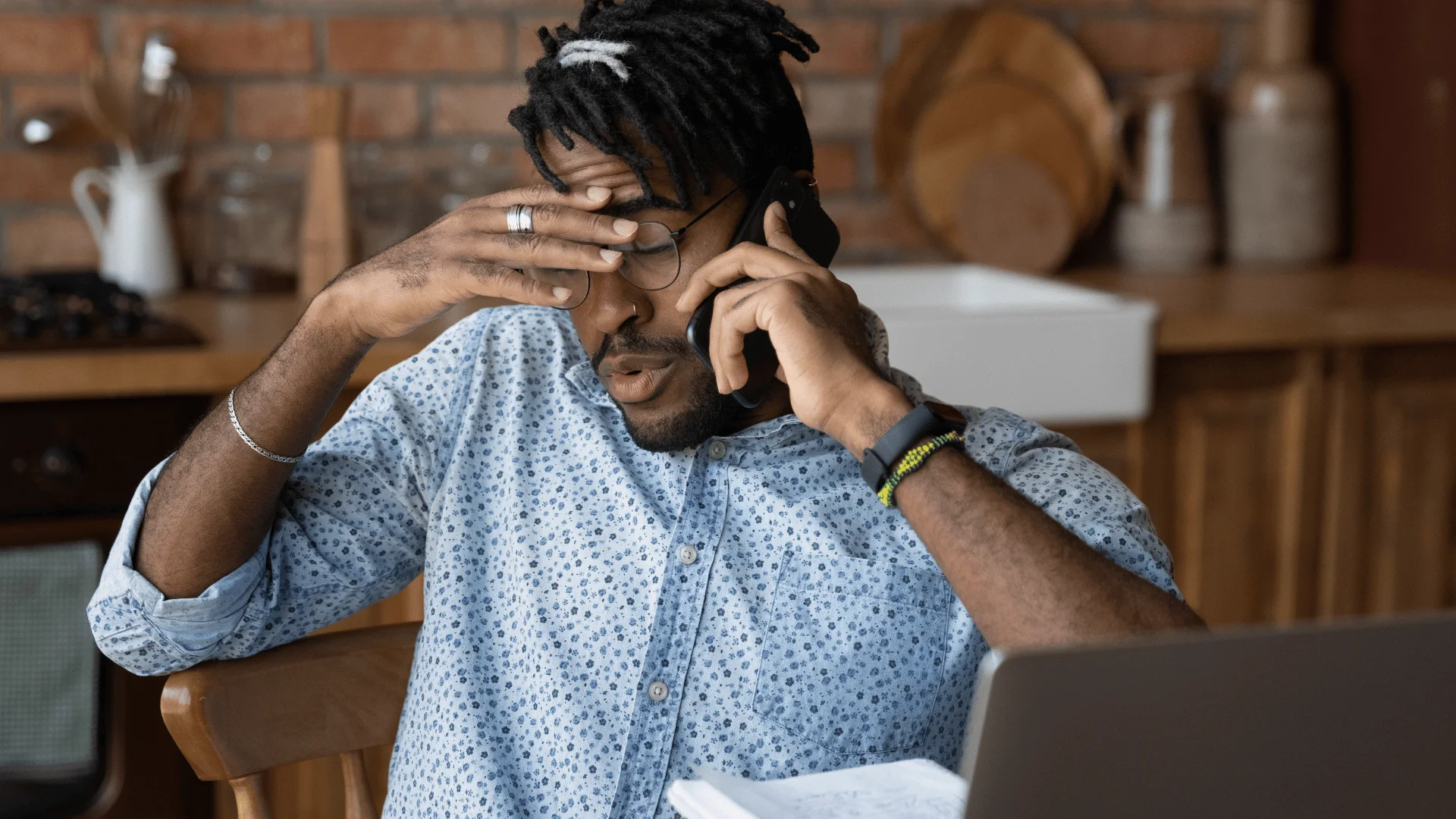 Man who needs a break looks stressed in front of a computer at home