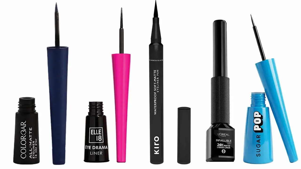 A studio lineup of five popular liquid and pen eyeliners from drugstore brands available in India, arranged against a clean white background. From left to right: Colorbar All-Matte Eyeliner (16 Hrs Stay) with its dip Applicator unscrewed, Elle 18 Eye Drama Liner in its classic black bottle with a tall hot pink cap, Kiro Waterproof Soft-Matte Eyeliner Pen in a sleek carbon black felt-tip body with its cap resting nearby, L'Oreal Paris Infaillible Grip 24H Matte Liquid Liner with a textured black handle, and a bright sky blue bottle of Sugar Pop Liquid Eyeliner with its dip brush Applicator drawn out