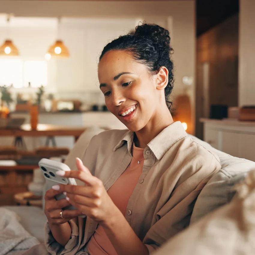woman smiling reading text from reliable friend