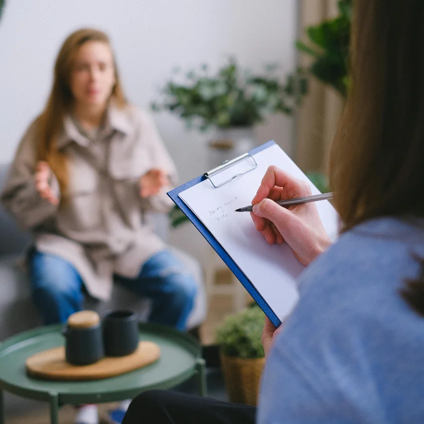 woman participating in therapy session to improve her mental health