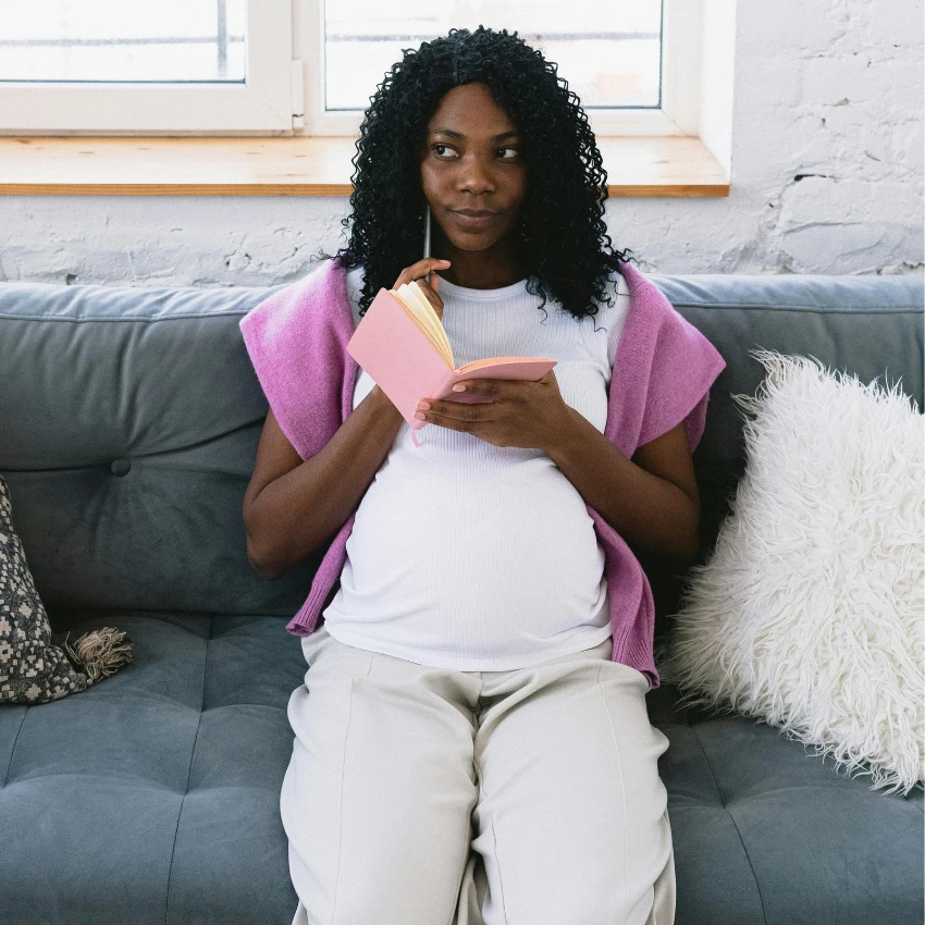 pregnant woman making a list of possible baby names