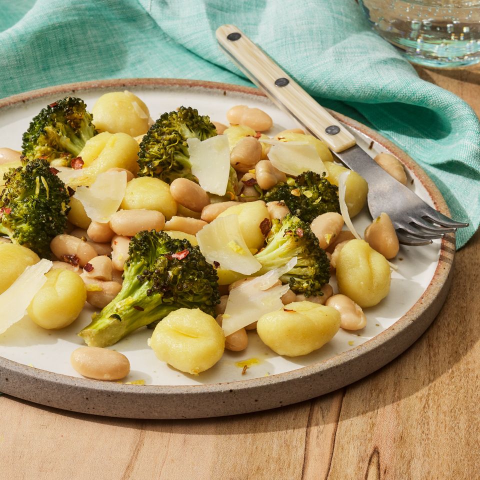 a recipe photo of the Sheet-Pan Gnocchi with Broccoli & White Beans Credit: Photographer: Fred Hardy, Food Stylist: Jennifer Wendorf, Prop Stylist: Lydia Pursell