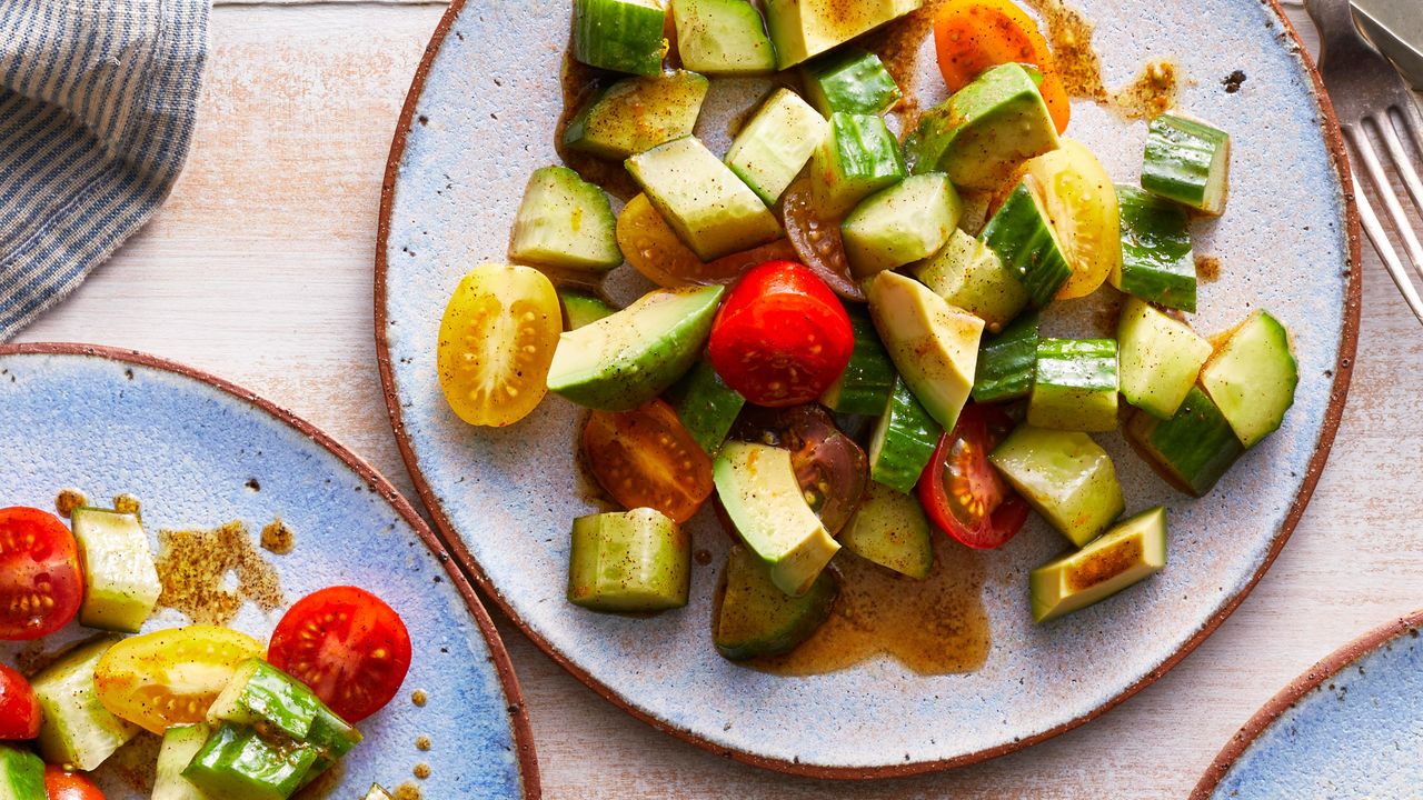 plate with cucumbers, tomato and avocado
