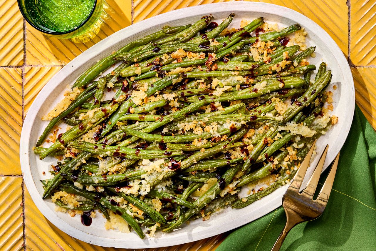 Recipe image of Smashed Green Beans with Parmesan & Balsamic Credit: Photographer: Robby Lozano, Food Stylist: Amanda Holstein, Prop Stylist: Keoshia McGhee.