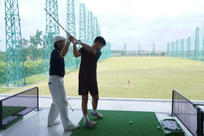 Instructor guiding student in a golf class. Photo courtesy of Shattuck St. Marys Vietnam