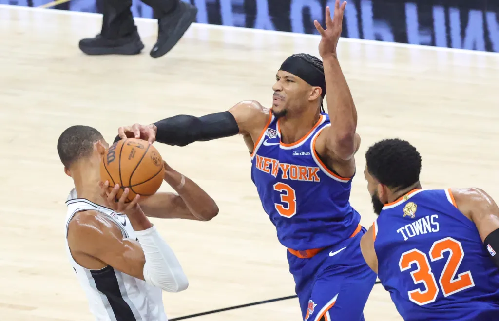 New York Knicks guard Josh Hart #3 knocks the ball away from San Antonio Spurs forward Victor Wembanyama #1 in the first quarter.
