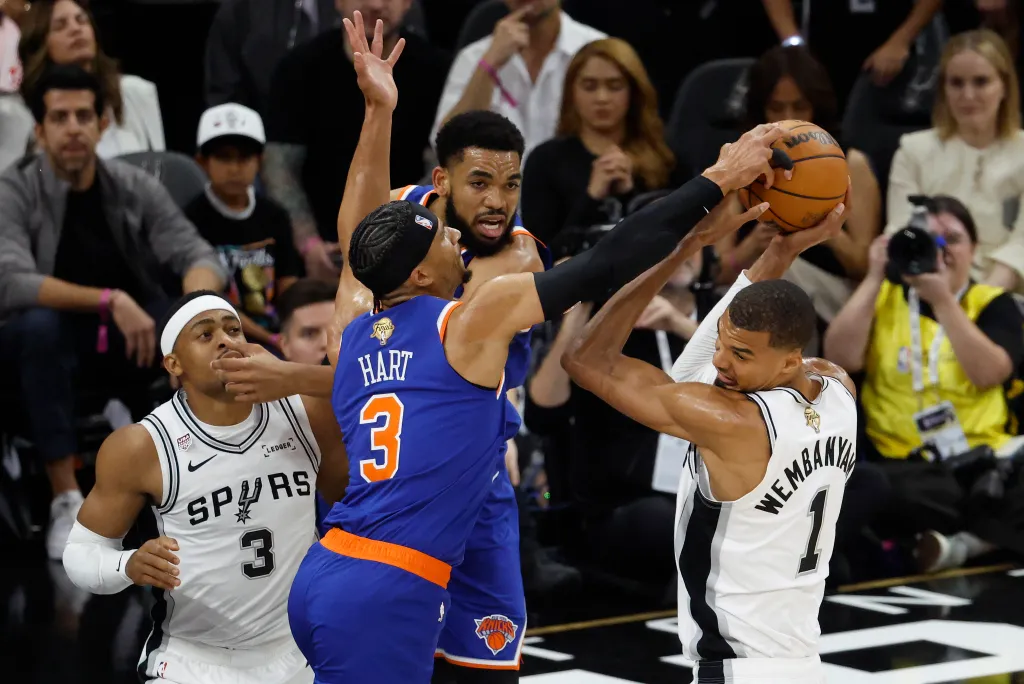 New York Knicks guard Josh Hart knocks the ball away from San Antonio Spurs forward Victor Wembanyama in the first half at Frost Bank Center.