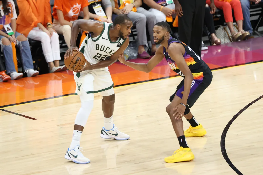 Mikal Bridges plays defense on Khris Middleton of the Milwaukee Bucks during Game 5 of the 2021 NBA Finals on July 17, 2021 at Footprint Center in Phoenix, Arizona.