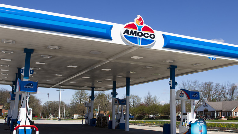 An Amoco gas station with the torch logo overhead