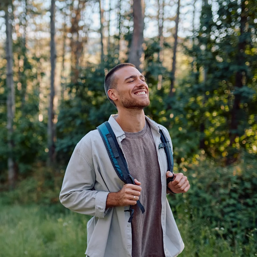 happy man walking outside in nature
