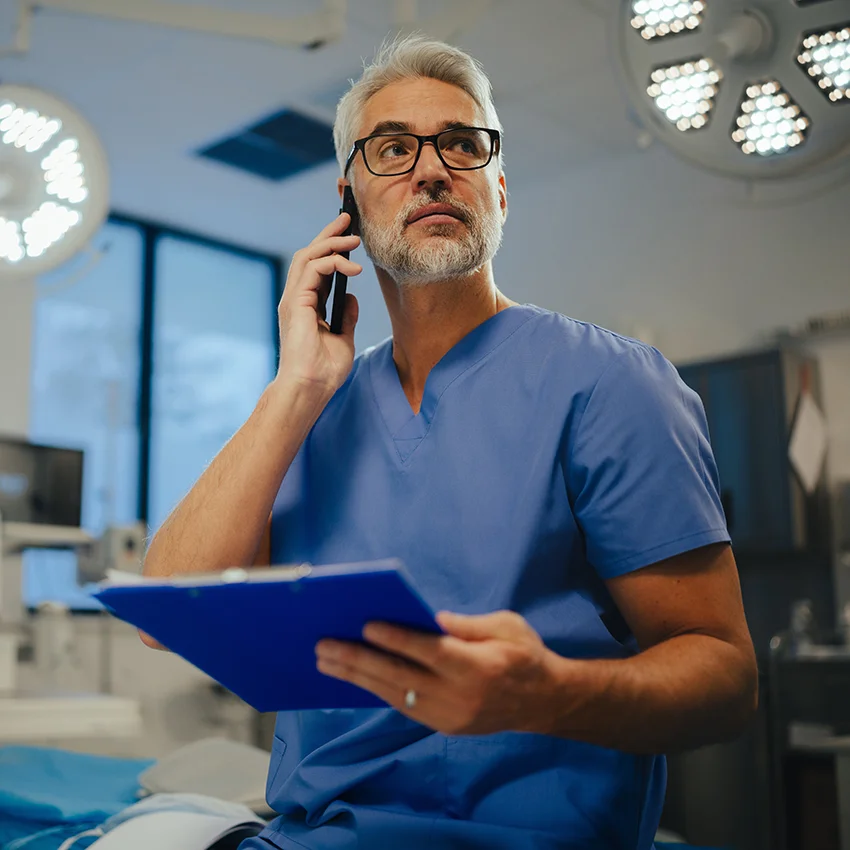 ER doctor taking serious phone call
