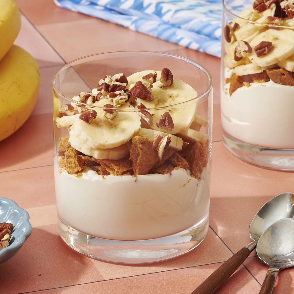A dessert parfait with layers of banana slices nuts and frozen yogurt in a clear glass Credit: Diana Chistruga
