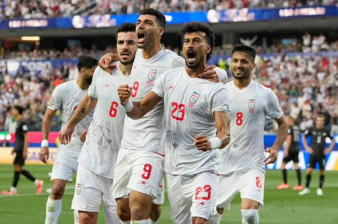 Iran players celebrate after scoring in the match against New Zealand. Photo by AP