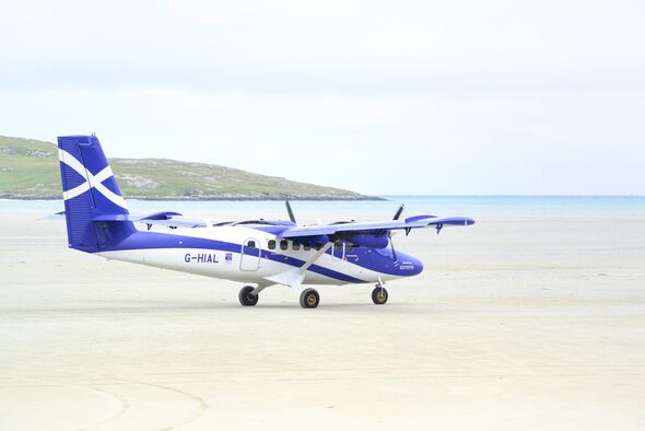 A Loganair Viking DHC-6-400 Twin Otter taxiing before take-off at Barra Airport(Scotland,UK), believed to be the only airport i A Loganair Viking DHC-6-400 Twin Otter taxiing before take-off at Barra Airport(Scotland,UK), believed to be the only airport i