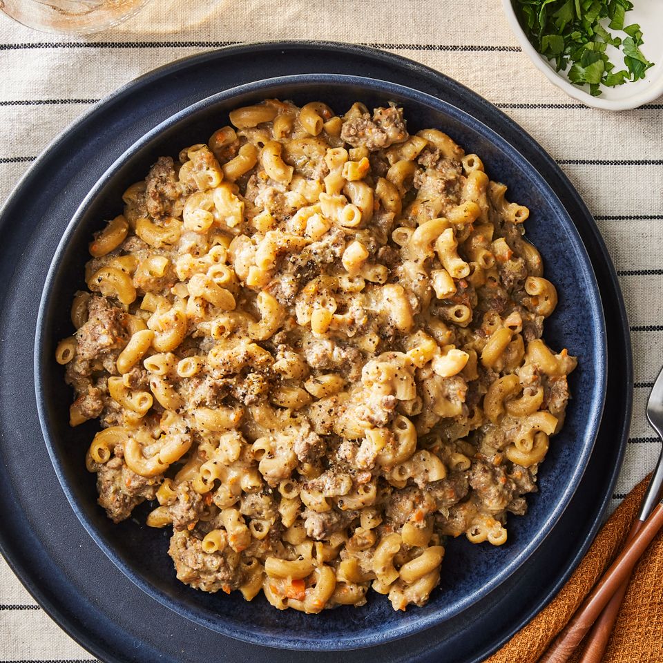 A dark blue plate with a serving of the copycat hamburger helper recipe Credit: Photographer: Rachel Marek, Food Stylist: Addelyn Evans, Prop Stylist: Gabriel Greco
