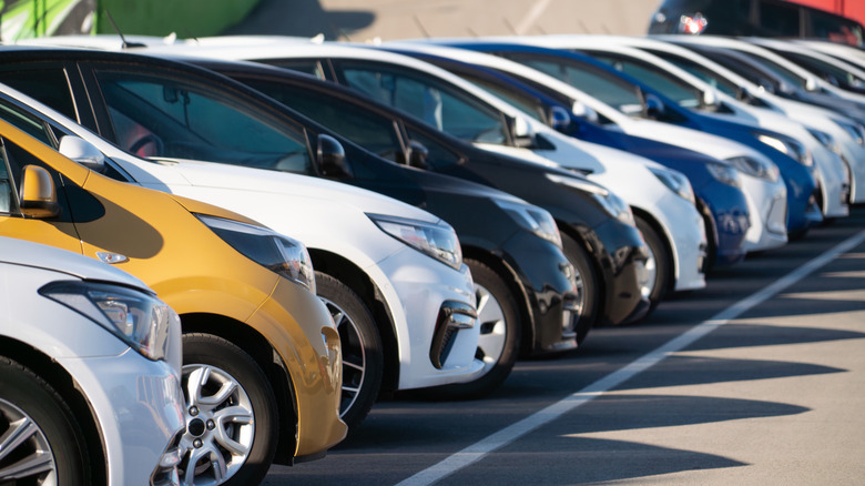 A row of used cars in a dealership lot